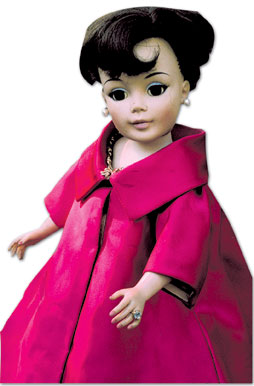 This 21-inch “Jacqueline Kennedy” portrait doll from the 1960s is dressed in a copy of the First Lady’s inaugural ball gown and cloak. Notice her ring and the tag (far right).