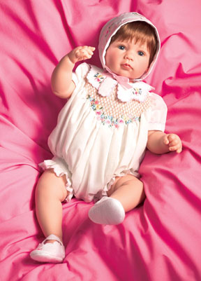 “Simple Treasures” wears apparel designed by Martha Pullen. Her attire consists of a soft cotton romper, and features hand smocking trimmed with embroidery. Part of the Yesteryear Treasures series, the doll is attractively priced at $185.