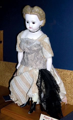 This papier-mâché/wax doll, circa 1890, is by an unknown maker.