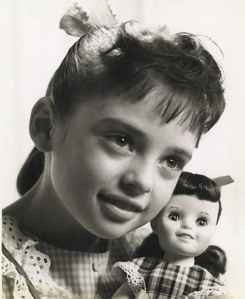 Young Angela and one of her doll likenesses.