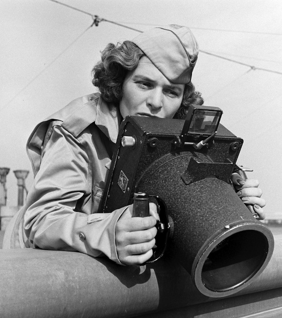 Margaret Bourke-White, legendary photographer, taking aim during wartime. Courtesy of Time Magazine Archives