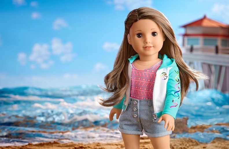 The Joss doll comes clad in a swimsuit, shorts, and hoodie. Her hearing aid is removable.