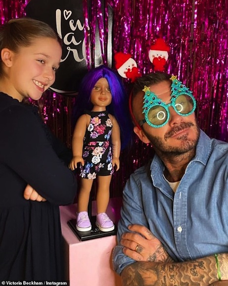David Beckham and daughter Hunter mug for the camera with their I’m a Girly accessories and doll. Photo courtesy of Victoria Beckham/Instagram