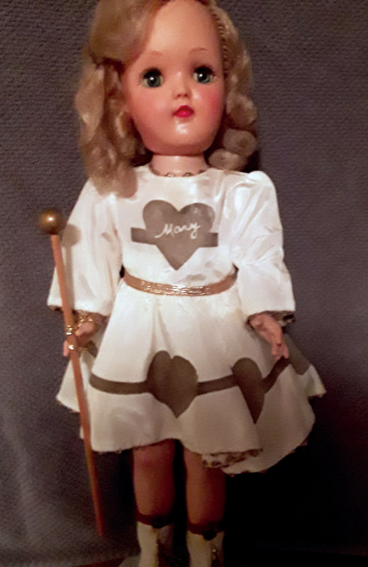 This rare Mary Hartline doll has a vinyl head with rooted hair and unusual white outfit.