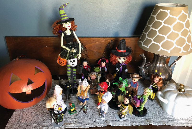 Janet Balas: “The Scary Godmother [the tallest doll] is one of my favorite Halloween characters. She was designed by Jill Thompson, the author and illustrator of the Scary Godmother books and animated series. The children with her are wearing costumes that I, my sons, and my granddaughter have worn over the years.”