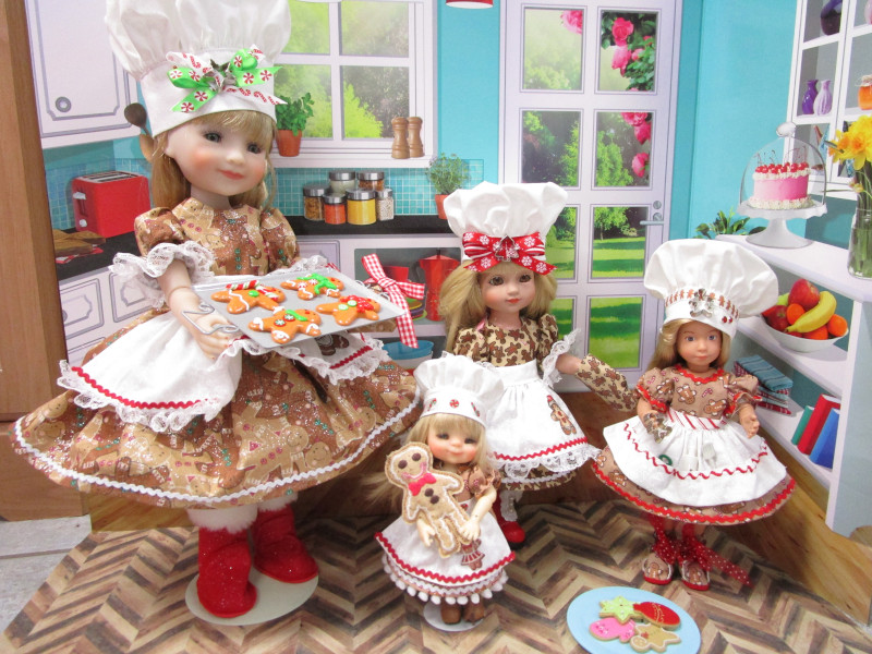 Linda Dryer: “Ruby Red Fashion Friends Sara, Kruselings Vera, Tonner 10-inch Sophie, and Meadow Doll twinkle Chara are all wearing Gingerbread outfits I made them. They love baking cookies!”