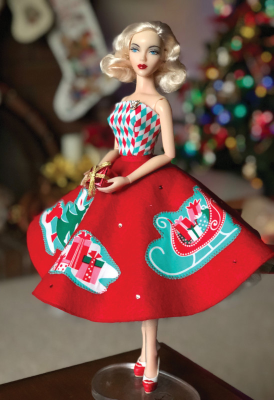 Suzanne McDonough: “JAMIEshow Gene celebrates the holidays in style. I created this fashion using a classic felt circle skirt, themed fabric, appliqué motifs, and crystals to add that extra holiday sparkle!”