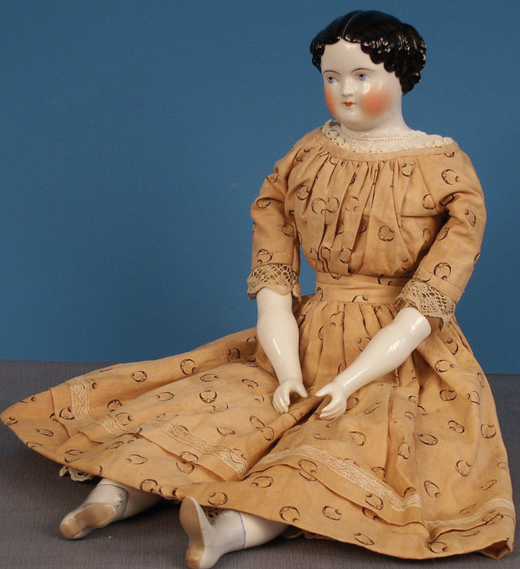 1860s china-head doll with modified flat-top hairdo.