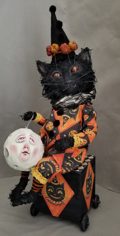 Gustave the Black Halloween Cat is sculpted from paper clay and covered with cotton cloth to create a realistic cat hair effect. Gustave was created in 2020.
