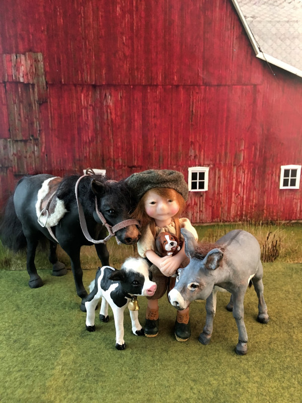 Polymer clay boy doll holding a puppy stands outside a barn with a pony, calf, and donkey.