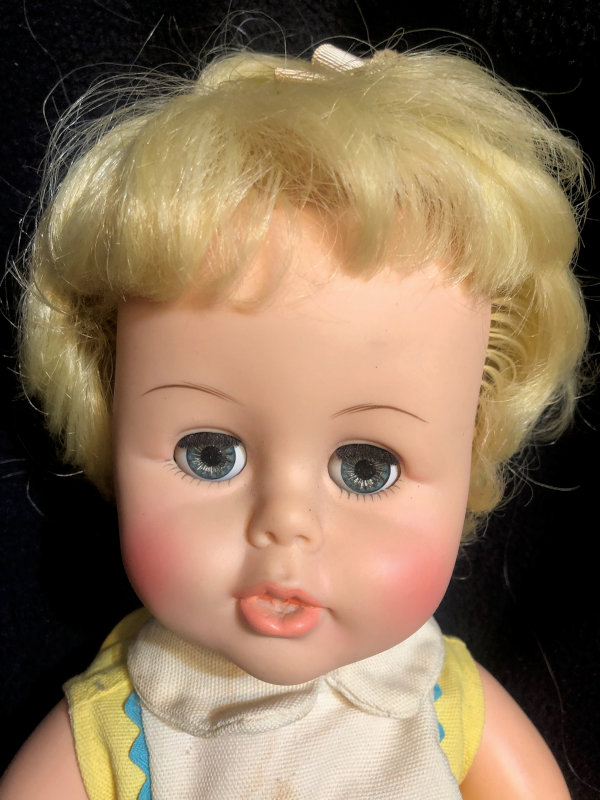 Closeup of face of 1966 Tiny Kissy Sears doll.