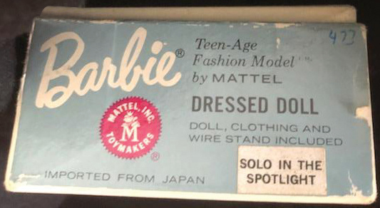 The Barbie dressed doll boxes named the included fashion with a sticker on the box end.