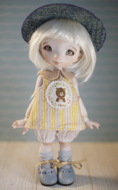 Goldilocks is a 7.5-inch porcelain BJD painted using China paints, to make the colors permanent. This is number four of a special customized limited edition of six. She has green/blue silicon eyes, dress, straw hat, and Italian leather shoes.
