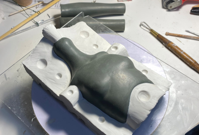 Work-in-progress photo of BJD torso in mold-making stage
