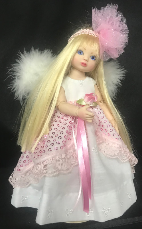 Angel of Love is the first in a series of angels designed by Stoehr. “She looks much like my granddaughter Megan, with the same soft look in her face,” the artist said. The 10-inch resin BJD has glass eyes and an outfit handmade by Bonnie Larson.