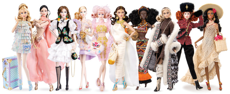 A line of 10 dolls in a variety of skin tones and dressed in different costumes in styles drawn from around the world.