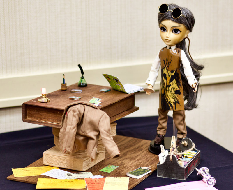 The Haunted Library was the 2021 event theme. Harold Santamaria’s competition entry, The Book Maker, featured books that moved about the table on their own and was awarded Best in Theme.