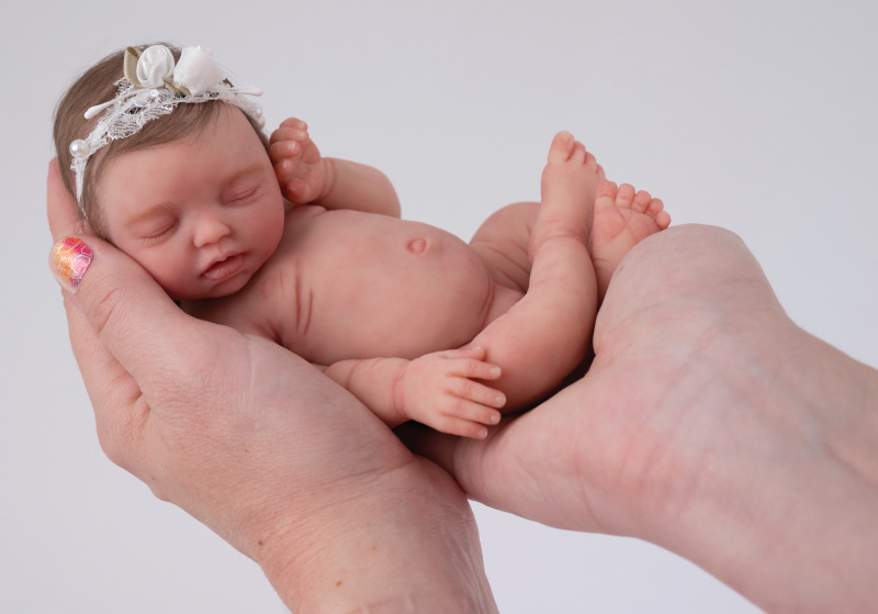 Maria Lynn’s 10-inch Bailey Asleep is cast in silicone. The doll can take a small bottle or pacifier and is available with posing armatures.