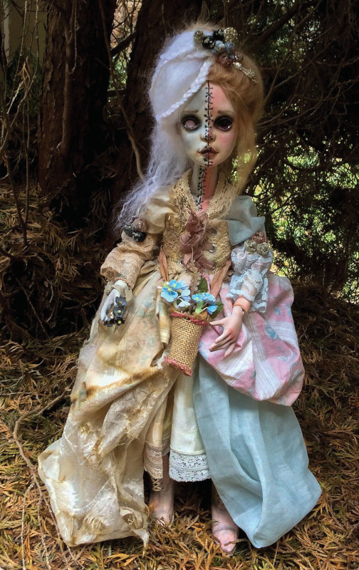 Torn Between Life and Death, 20 inches, is sculpted from Ladoll Premix clay. Her clothing is handmade from vintage fabric which has been distressed further on the ghost side of the doll. She was part of a show at Lovetts Gallery called Duets.