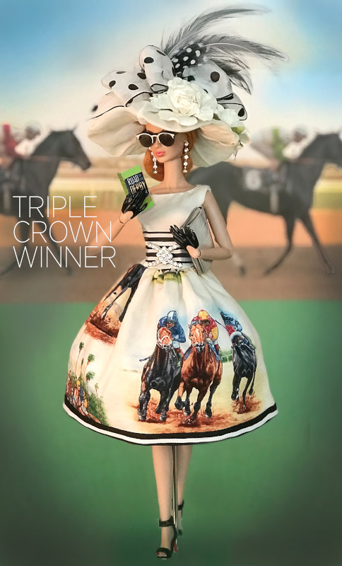 “Triple Crown Winner was a OOAK donation for the Grant-A-Wish ‘Off to the Races’ Doll Convention. Integrity’s Victoire Roux wears a retro-inspired full skirt printed with jockeys and thoroughbreds. The striped belt with bejeweled crystal buckle and oversized plumed hat completes the ensemble. She won a DAE Industry’s Choice Award in 2019.”