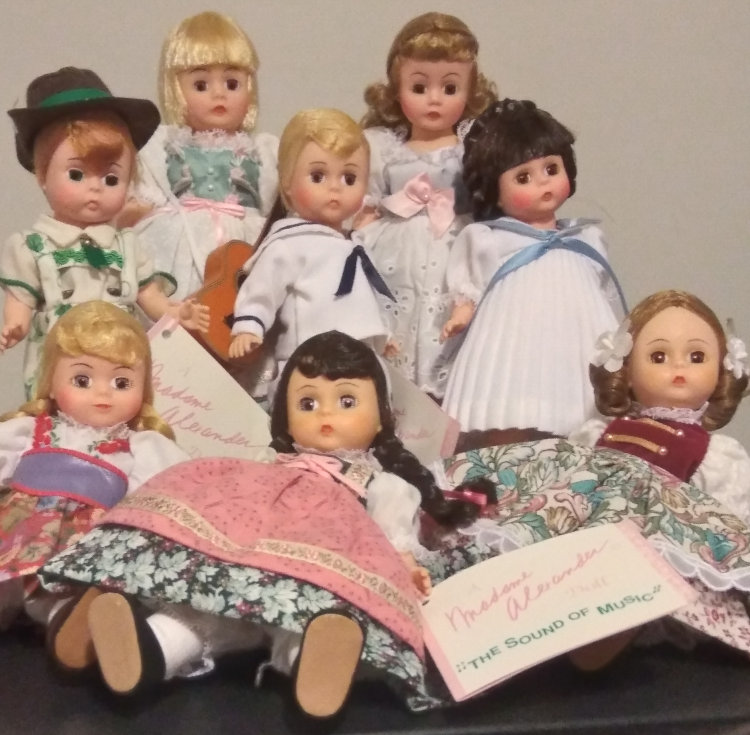 Eight dolls depicting characters from The Sound of Music, all in different outfits.