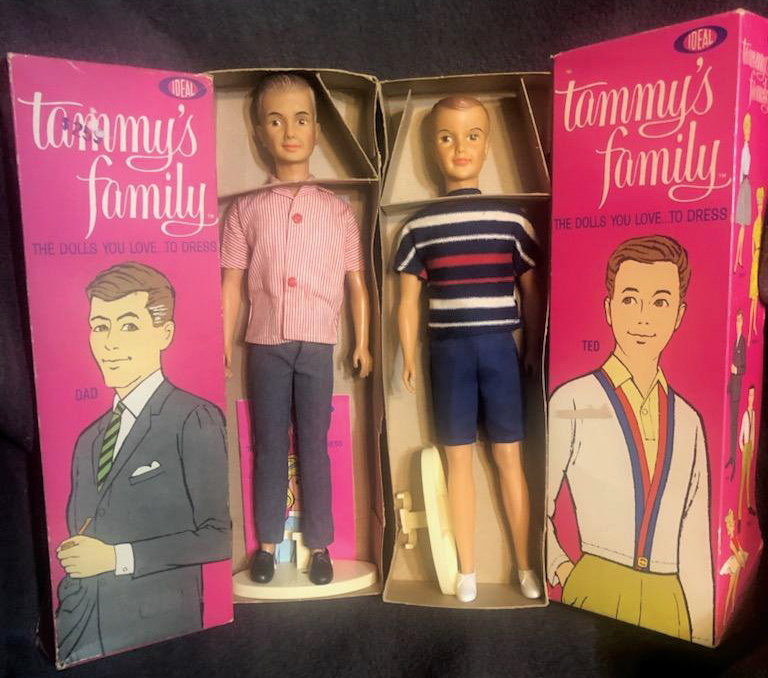 A doll depicting Tammy's Dad (left) next to a doll of Ted, Tammy's brother. The illustrated box lids are shown next to each doll.