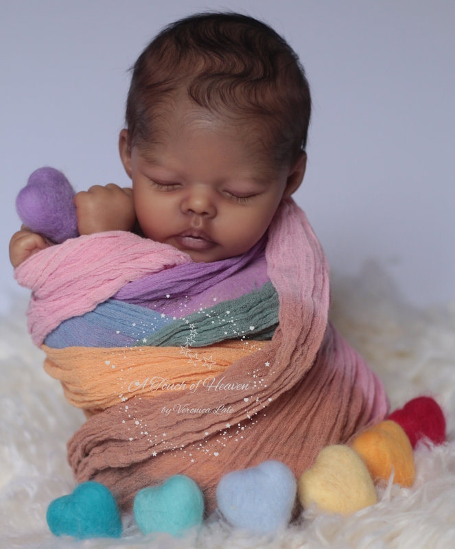 Realistic sleeping baby dolls, sitting upright in a colorful wrap.