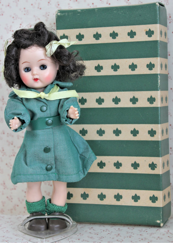 Plastic doll of a child in a Girl Scout uniform.