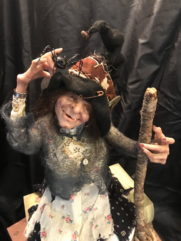 Doll with a witch's hat, broom, and spider