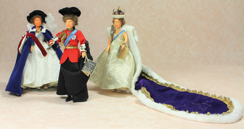 Nisbet Dolls of Queen Elizabeth II in Robes of the Most Noble Order of the Garter, Trooping the Colour Uniform, and Silver Jubilee Gown with Train.