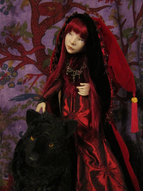 Doll with red hair and a red outfit stands beside a realistic-looking panther stuffed animal.