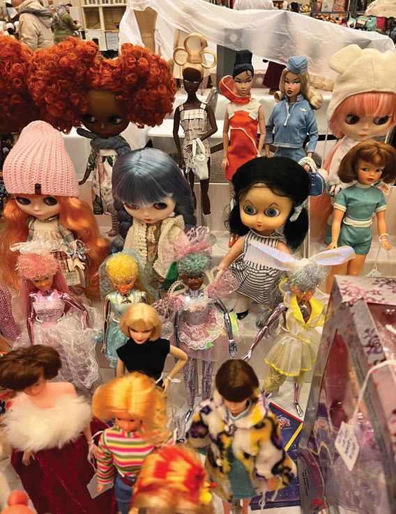 An assorted collection of modern and retro dolls displayed on a table