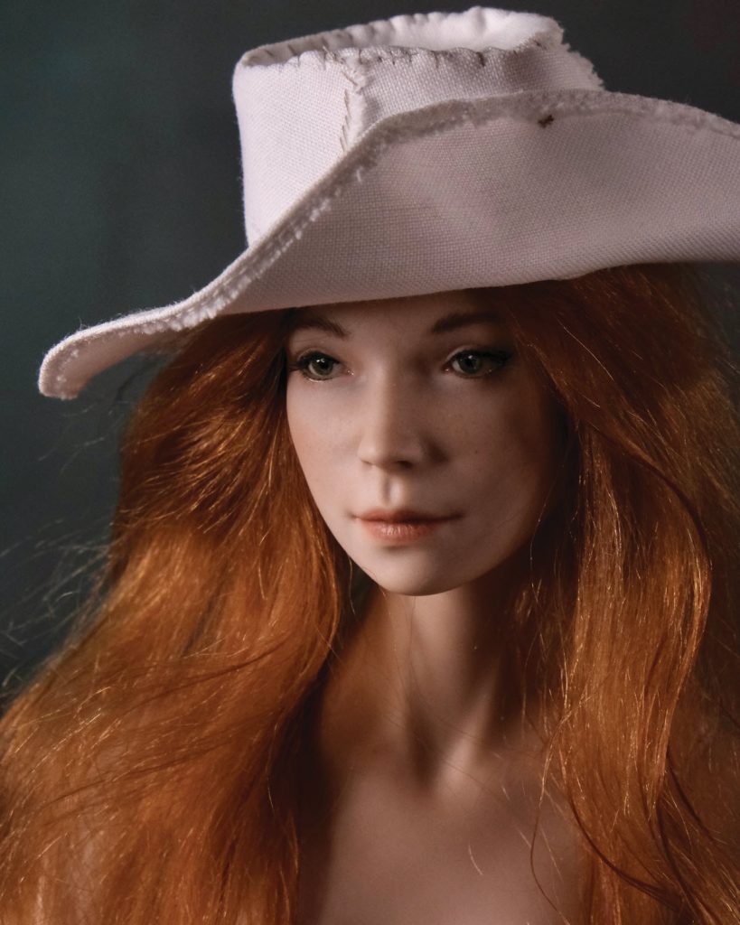 red haired doll with hat