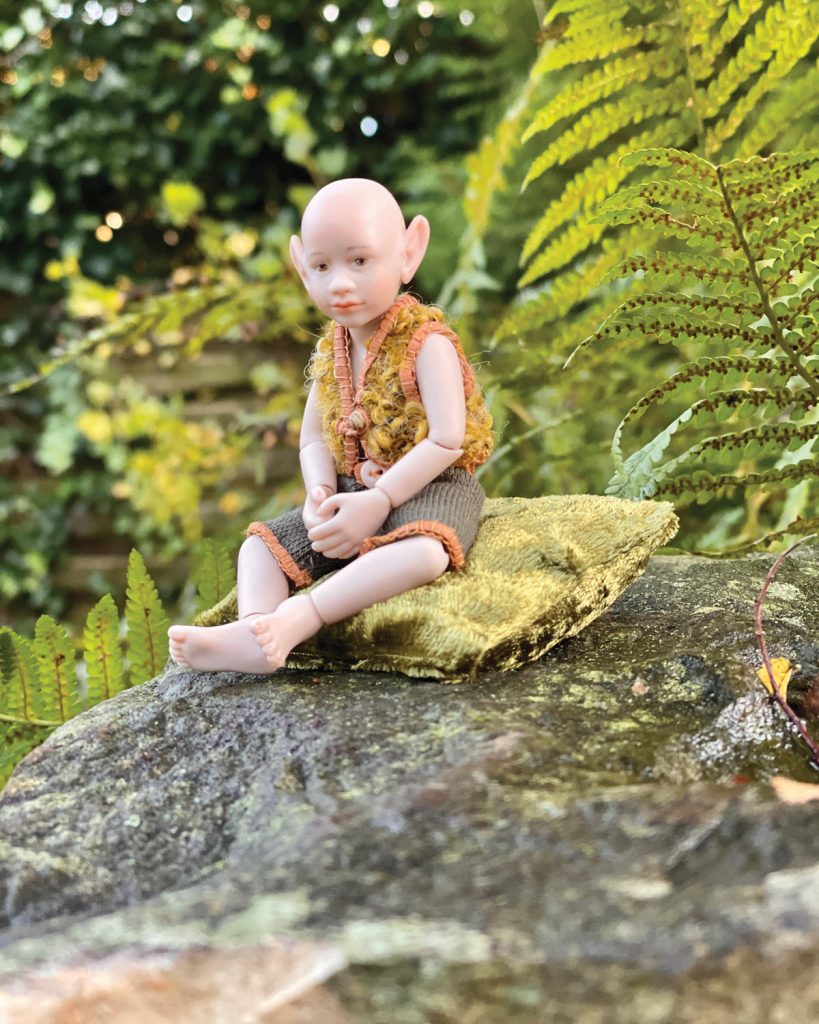 small elf doll on rock outdoors