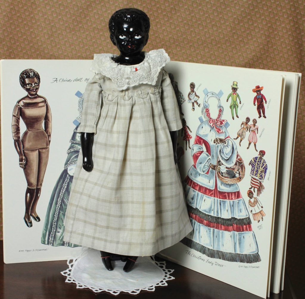 black china doll with paper doll look alike