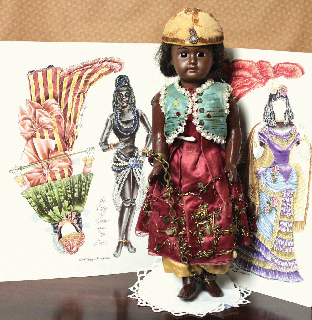 doll in Sudanese dress with paper doll look alike