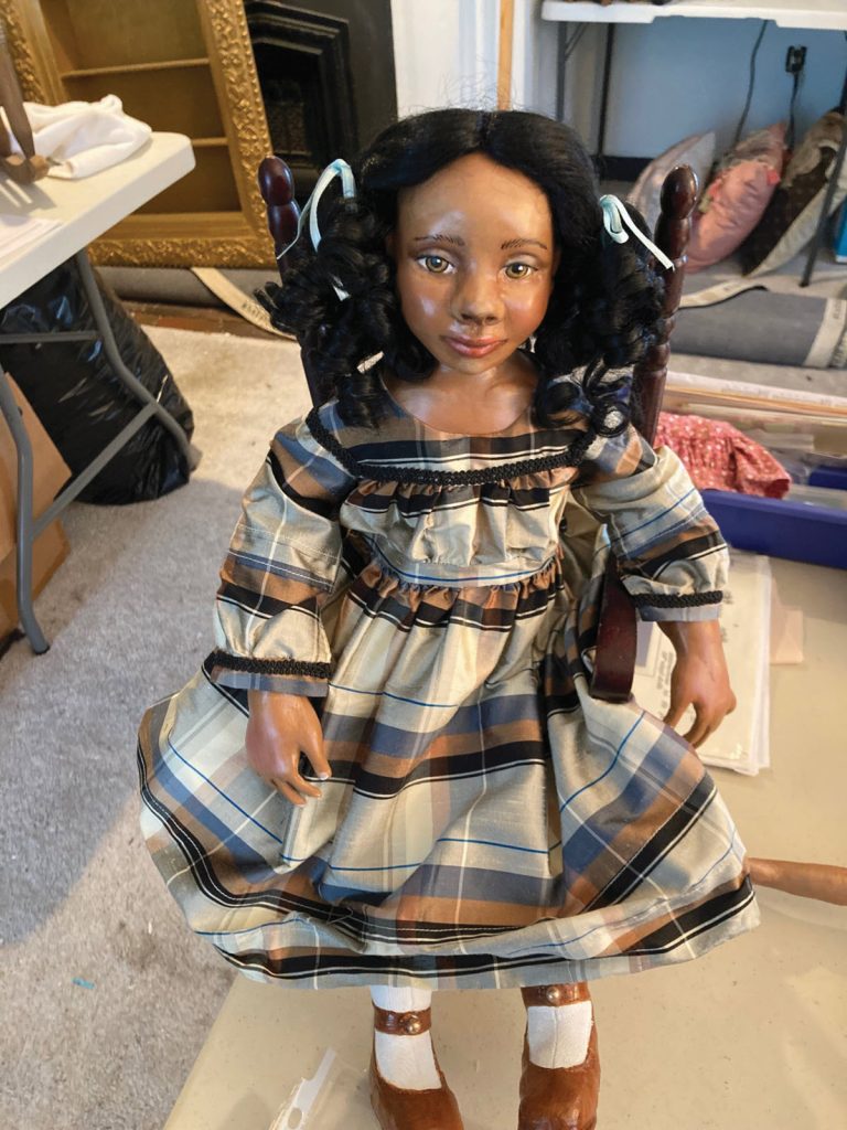 African American doll in plaid dress