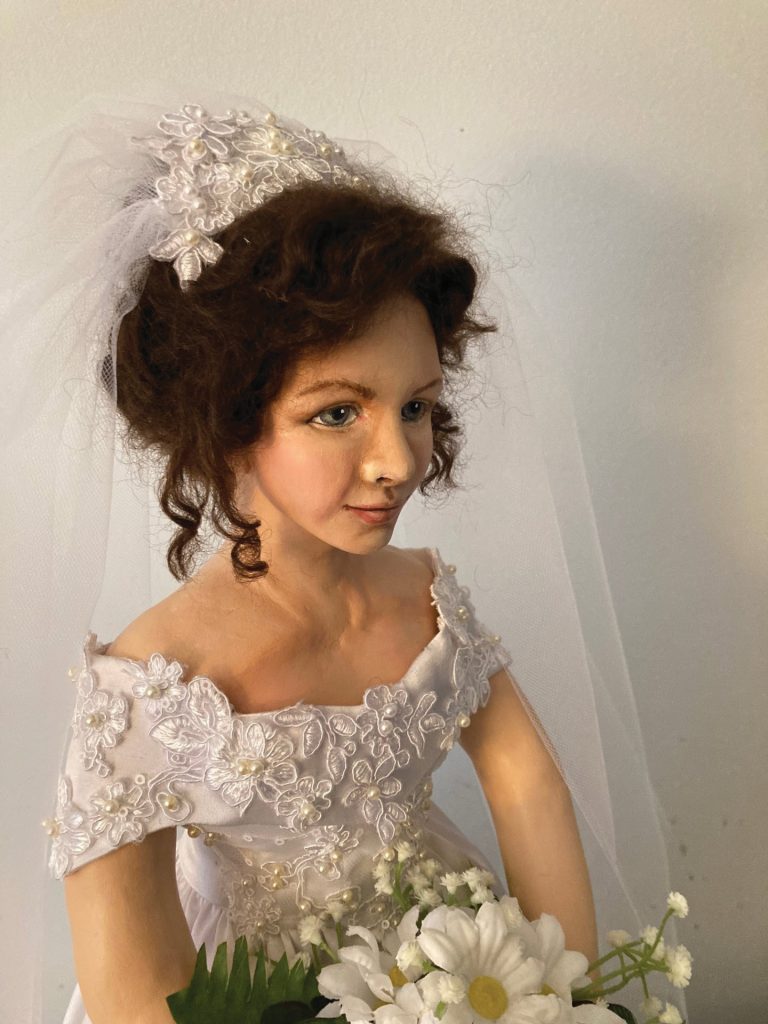 brunette doll in wedding dress and veil