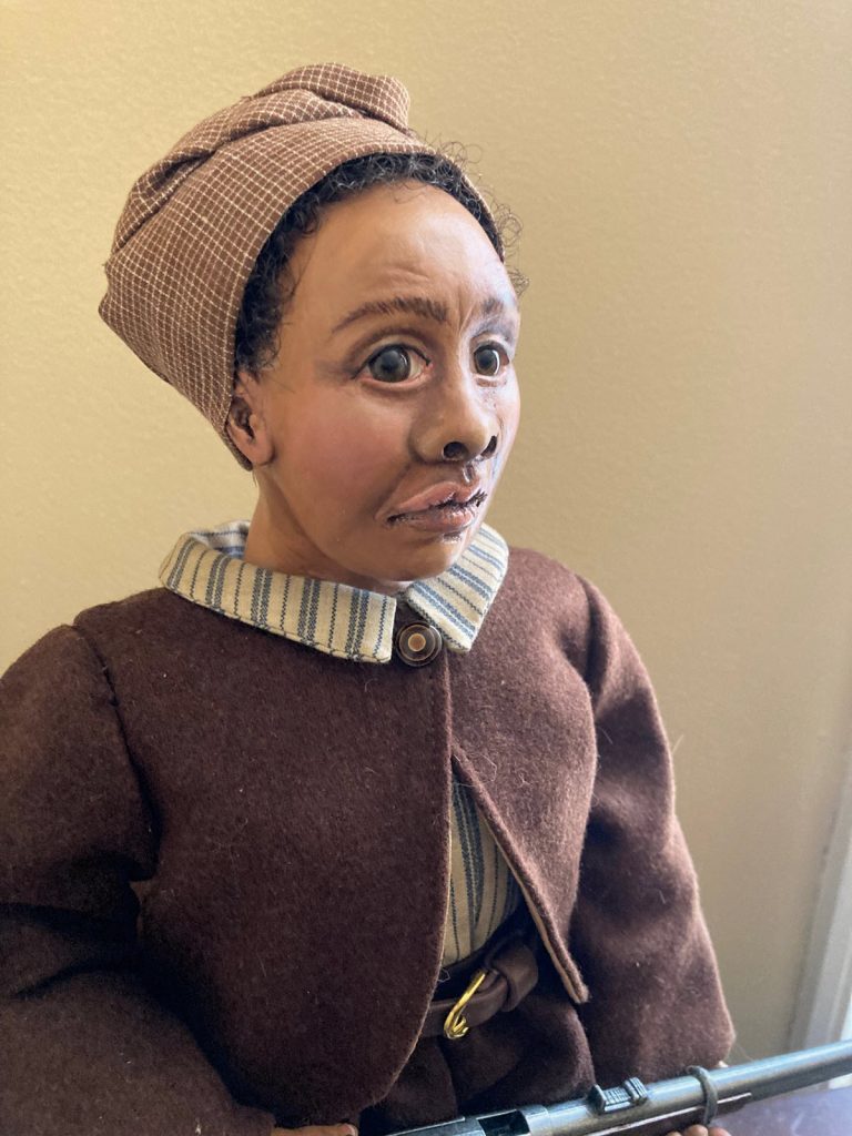 African American historic doll rendering of Mary Fields in brown postal worker clothing