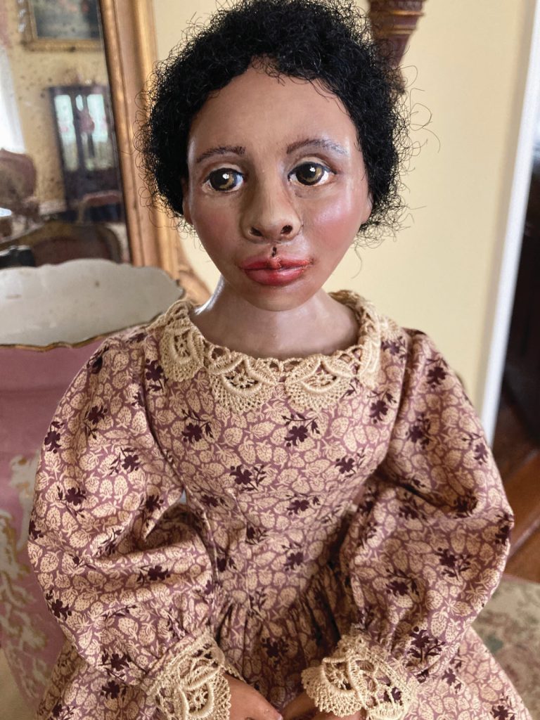 African American historic doll rendering of Mary Bowser in floral dress