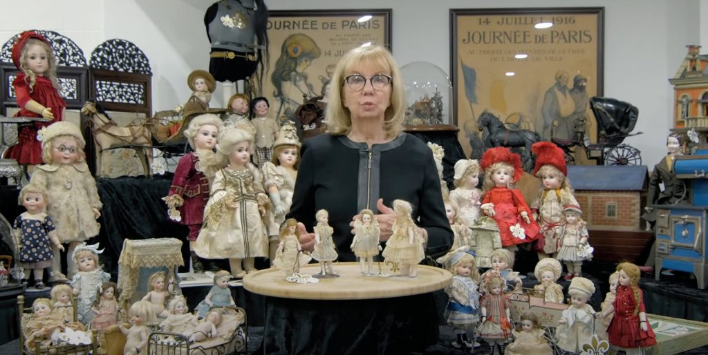 woman with dolls for a doll auction