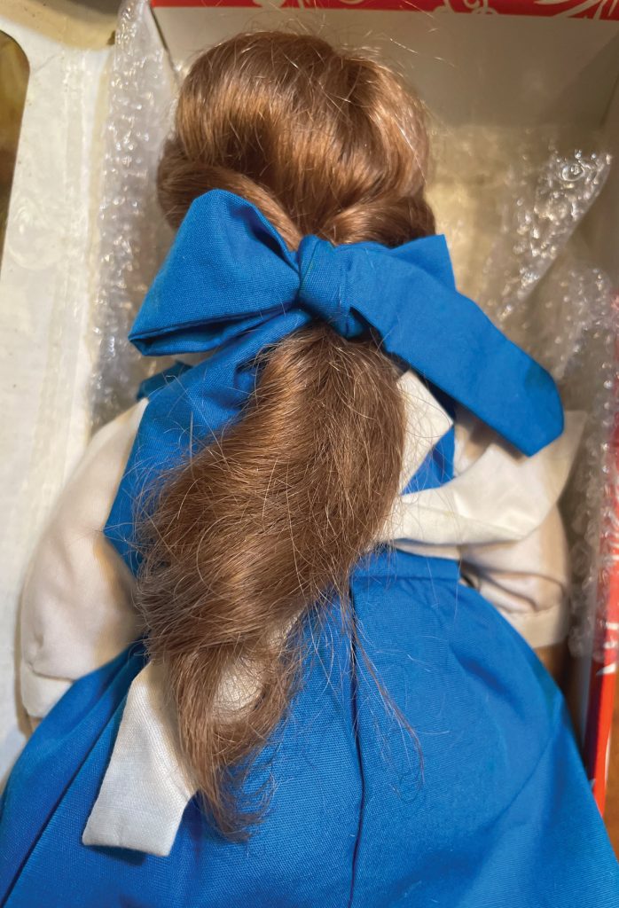 view of collectible doll belle back
